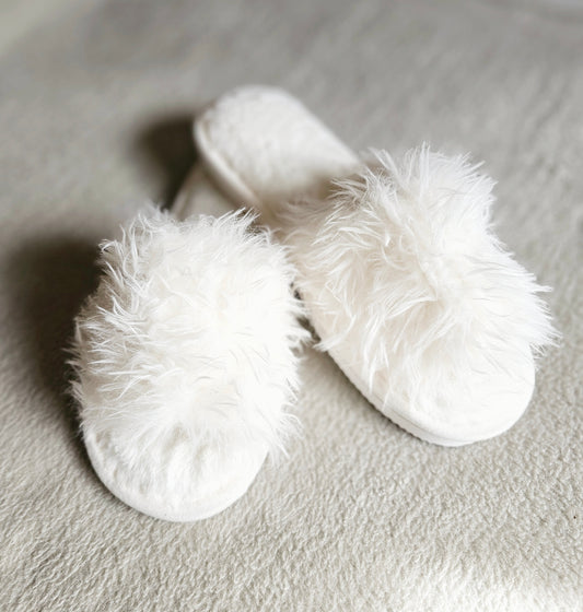 Cozy ivory fluffy slippers featuring soft faux-fur lining and cushioned footbed